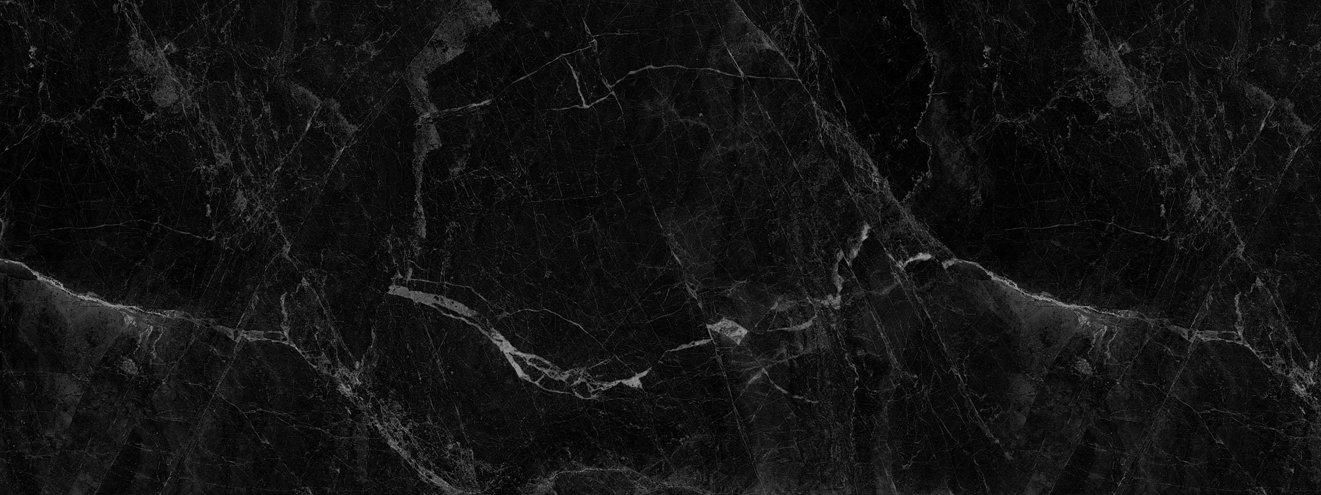 Black marble texture with white veins.