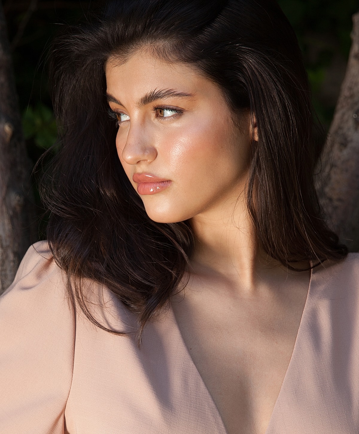 Woman with long hair in soft lighting.
