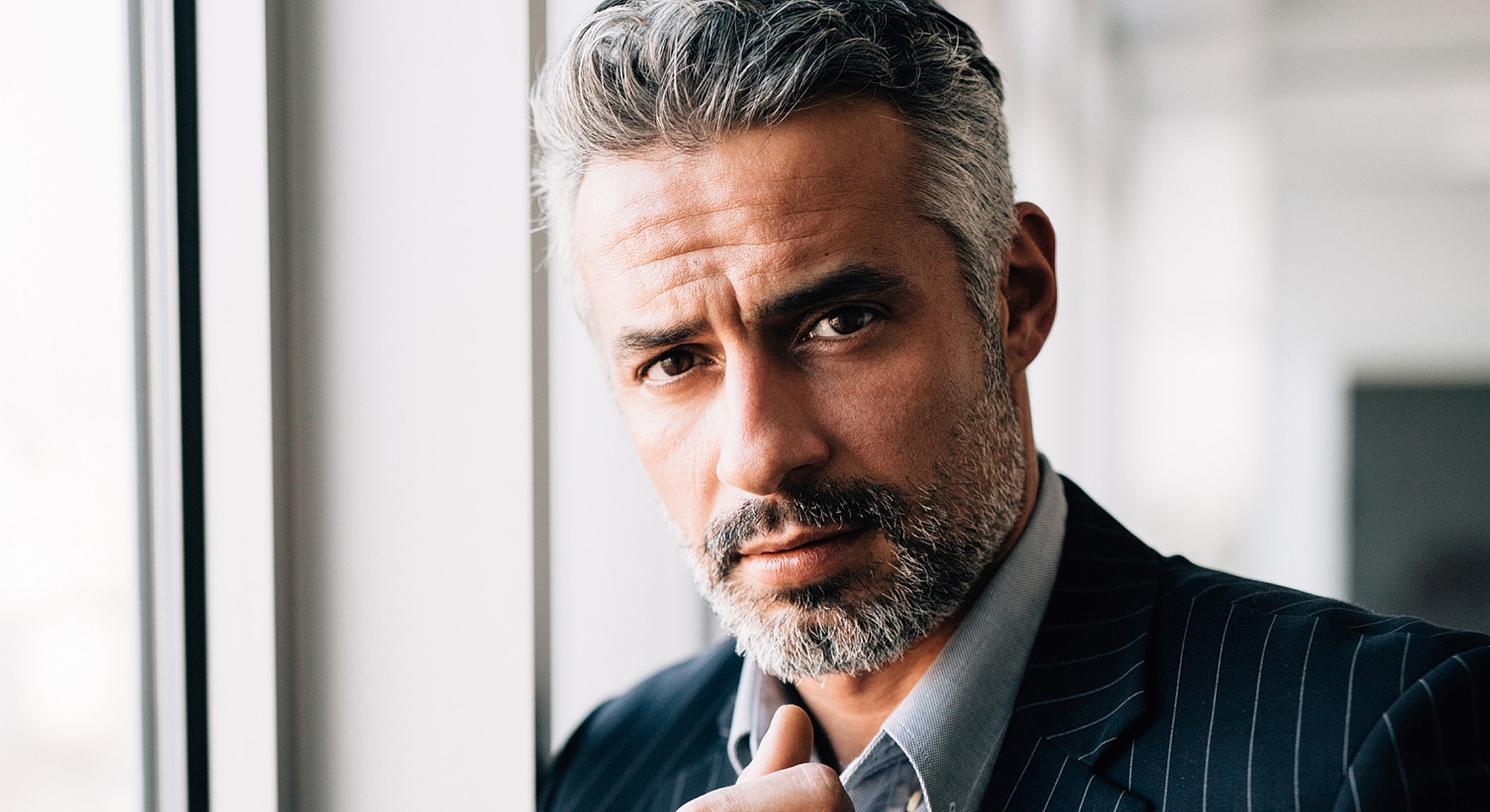 Professional man with gray hair and beard.